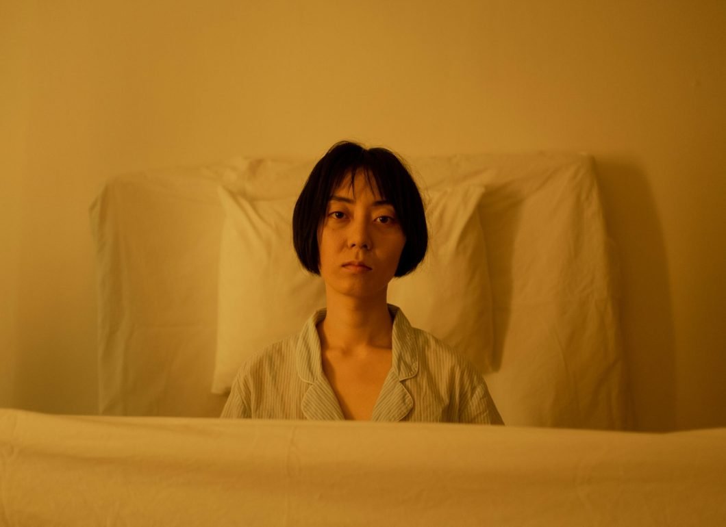 pexels-photo-6753829-6753829 Portrait of a woman looking pensive and tired in soft lighting.