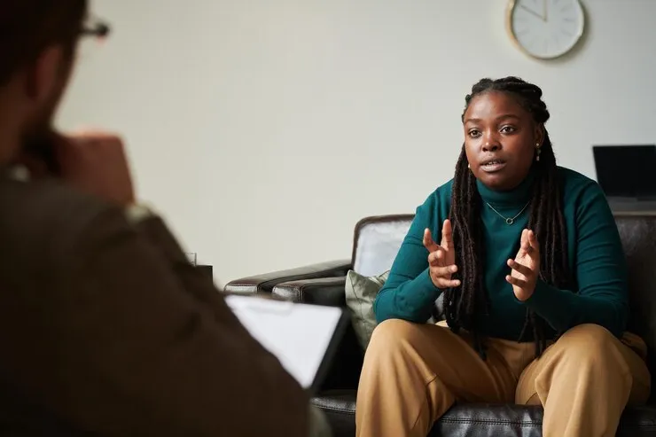 Young woman talking with a psychologist during a therapy session