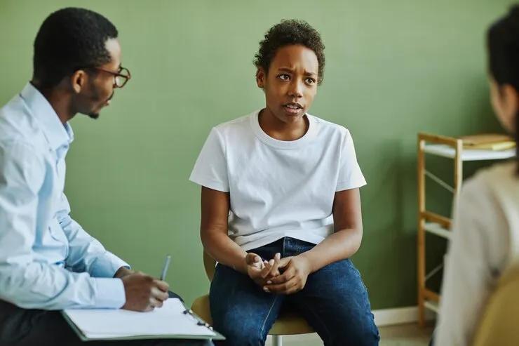 Teen discussing personal concerns with a mental health professional