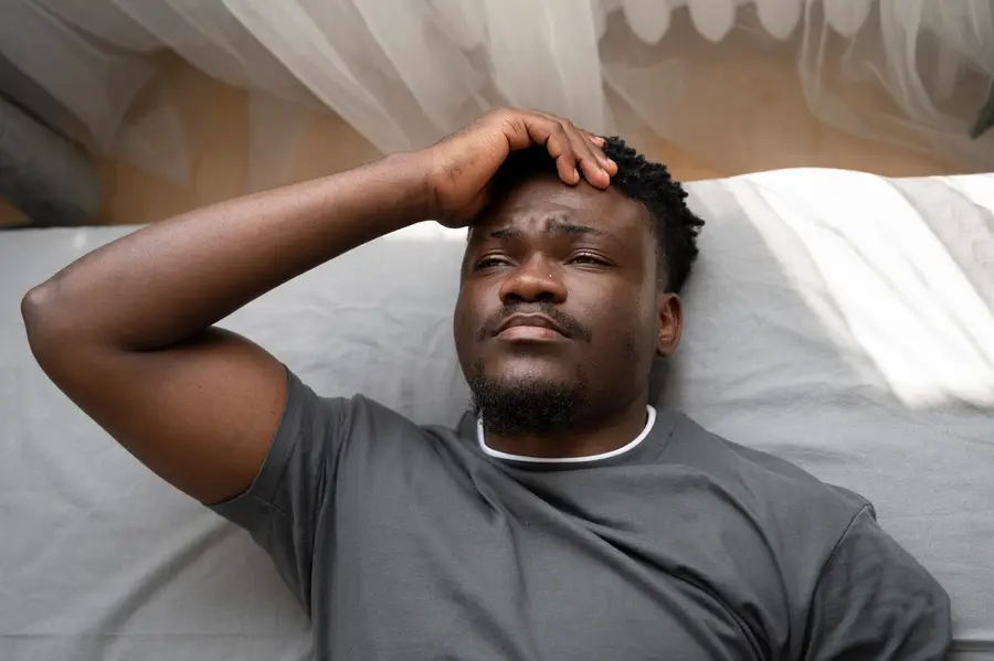 Man lying in bed dealing with anxiety and insomnia at Mentally Healthy Care