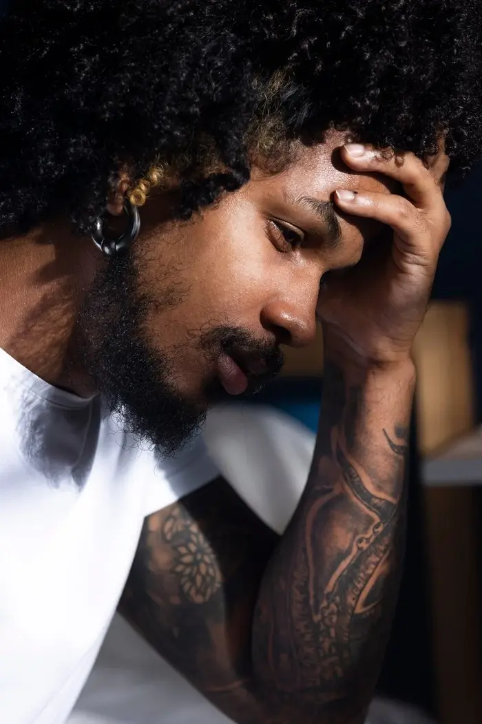 Man resting head in hand during a bipolar depressive episode at Mentally Healthy Care in Long Beach, CA.
