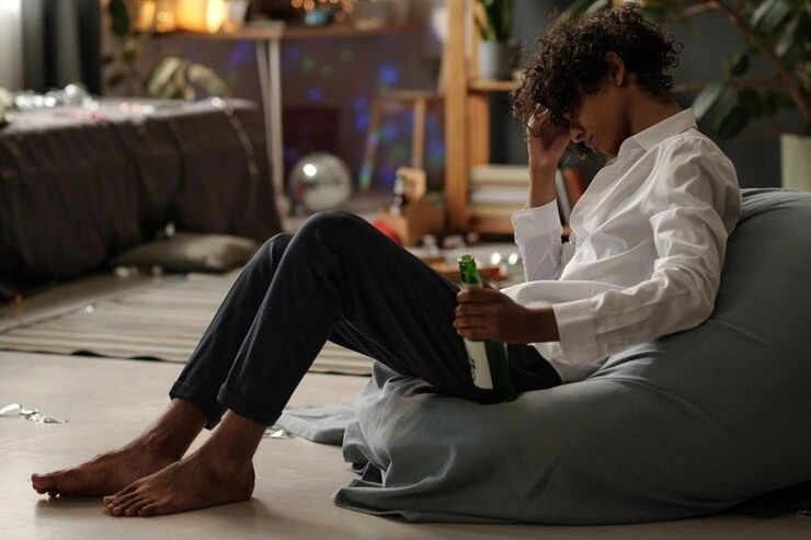 Young man struggling with alcohol use disorder sitting in a room at Mentally Healthy Care in Long Beach