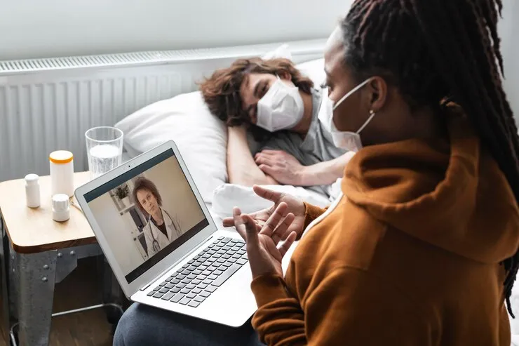 Young woman participating in a virtual consultation with a doctor